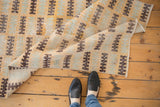 Distressed Modern Oushak runner with faded sea foam, saffron, brown geometric patterns.