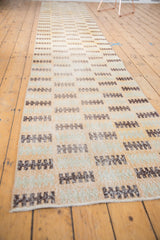 Distressed Oushak runner edge with even wear, faint foundation, sea foam, and brown patterns.