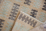 Distressed modern Oushak rug runner, revealing chocolate brown geometric patterns and secured edge.
