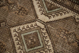 Geometric medallions and hook motif detail on vintage Serab rug, showing faint foundation.