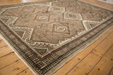 Detailed corner of vintage Persian Serab rug, geometric motifs in brown, ivory, powder blue.