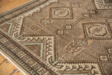 Vintage Persian Serab rug, detail of geometric brown and ivory medallions with faded powder blue.