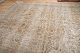 Distressed vintage Sivas carpet with allover palmette and floral vinery in faded beige and brown.