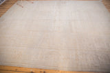 Vintage distressed Oushak carpet with low pile and subtle tone-on-tone ivory-beige patterns.