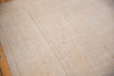 Distressed Oushak carpet pile showing storied texture, faint foundation, and soft ivory patterns.