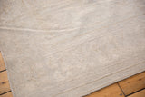 Low pile and distressed texture on a Vintage Oushak carpet with subtle ivory tones.
