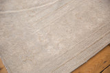 Distressed vintage Oushak rug showing low pile, even wear, and faint foundation.