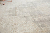 Distressed texture of a vintage Turkish Sparta carpet, showing faded curvilinear motifs in slate grey and ivory.