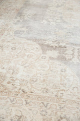 Distressed vintage Sparta carpet showcasing faded ivory and slate grey curvilinear motifs.