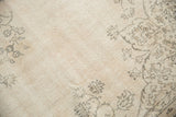 Distressed ivory vintage Sivas rug with charcoal floral motifs and even wear.