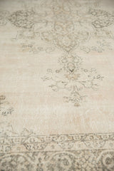 Distressed vintage Sivas rug showcasing faded ivory field and charcoal curvilinear floral motifs.