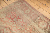 Distressed texture and abrashed pile of a vintage Anatolian rug with faded raspberry and antique ivory colors.