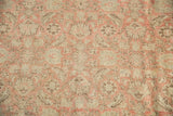 Faded blush and antique ivory herati motif on distressed vintage Anatolian rug texture.