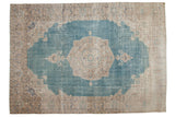 Vintage distressed Sivas carpet with a beige medallion and spandrels on a faded sky blue field.