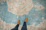 Showing the mostly even wear and low-pile texture of a distressed vintage Sivas rug.