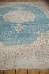 Angled view across the distressed pile of a vintage Sivas carpet in sky blue and beige.