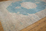 Angled perspective of a distressed Sivas carpet highlighting the beige corner spandrel and sky blue field.