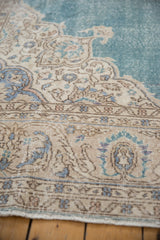 Even wear on the vintage Sivas carpet's beige corner spandrel against a sky blue field.