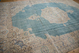 Angled view of the vintage Sivas carpet's scrolled beige corner spandrel.
