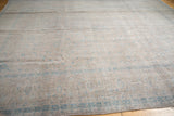 Distressed Kashan carpet edge, showing faint powder blue motifs on dusty apricot with even wear.