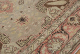 Distressed vintage Kaisary rug with soft beige, terracotta, slate blue floral motifs.