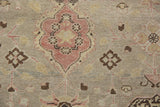 Distressed vintage Kaisary carpet detail with faded terracotta motif and even pile wear.