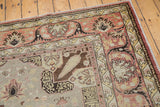 Softly worn vintage Kaisary carpet corner, featuring terracotta borders and blue floral pattern.