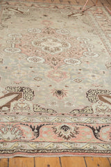 Distressed vintage Turkish Kaisary rug lower border with muted terracotta, beige, and blue floral patterns.