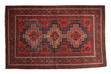 Vintage Belouch carpet with triple geometric medallions, cherry red, navy blue, and gold.