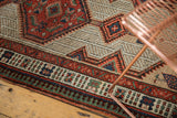 Geometric border and field patterns on a vintage Serab runner in red, pale sand, sky blue, green.