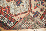 Folded corner of vintage Serab rug runner, revealing geometric pattern and woven foundation.