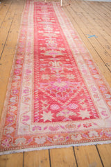 Distressed Oushak runner fringe and corner detail with softened pink and ivory vine borders.
