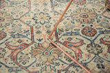 Distressed Mahal carpet close-up: ivory, terra cotta, blue Farahan Sarouk style arabesques, mostly even wear.
