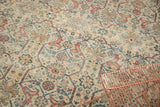 Distressed vintage Mahal carpet's intricate arabesque and paneled motifs in ivory, terracotta, and blues.