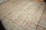 Intricate arabesques in Farahan Sarouk style on a distressed Mahal rug corner.