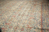 Mahal carpet: intricate arabesques, samovar motif, visible wear, ivory, terra cotta, and blue border.