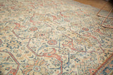 Textured distressed Mahal carpet with intricate arabesques in ivory, terra cotta, and muted blue.