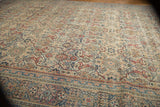 Distressed texture of the vintage Mahal carpet border and Farahan Sarouk-style arabesque field.