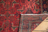 Brick red geometric Belouch runner, revealing fringe and its hand-knotted reverse.