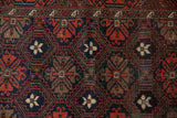 Vintage Belouch runner detail: geometric floral motifs in navy, red, coffee brown, ivory. Even wear, slight foundation showing.