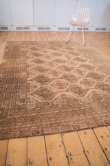 Distressed vintage Afghan carpet border with gul motifs and blush, coffee brown tones.