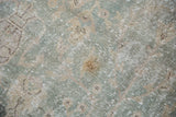 Distressed vintage Sivas carpet texture with pale ocean green, ivory, and localized wear.