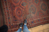 Antique Belouch tribal carpet displaying plainwoven kilim edge and geometric gul motifs with abrash.