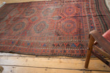Antique Belouch tribal carpet featuring geometric guls and serrated patterns.