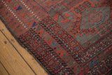 Antique Belouch rug with geometric borders, native tribal motifs, and original plainwoven kilim.