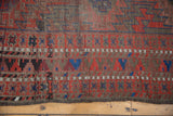Serrated geometric motifs and varied abrashes on Antique Belouch carpet pile.