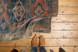 Vintage Distressed Veece rug, featuring low pile, exposed knot heads, dusty teal and burnt orange.