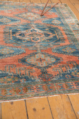 Distressed Vintage Veece rug end, showing white fringe and low pile revealing knot heads.