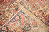 Intricate geometric vinery and visible foundation on folded vintage Ahar Heriz rug.