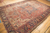 Vintage Heriz carpet's navy border with red vinery and prominent localized wear.